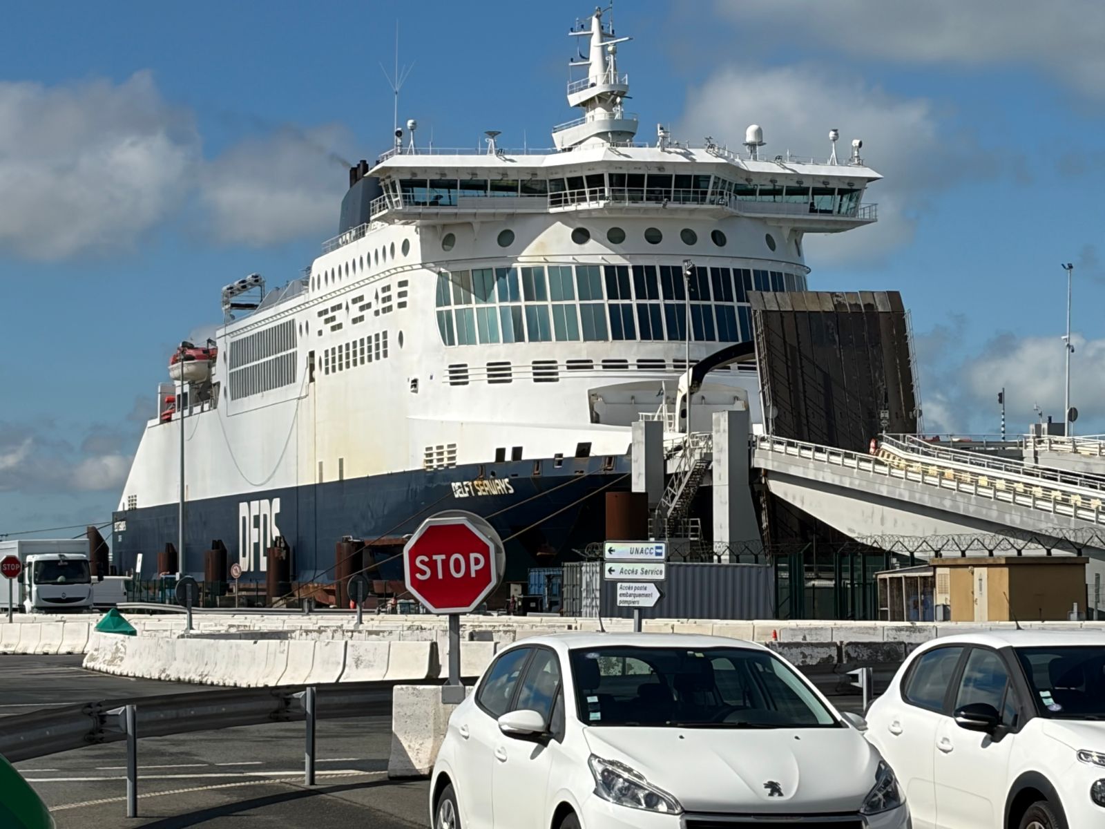 DFDS ferry Delft Seaways moored at Dunkirk with its bow raised and a stop sign in the foreground