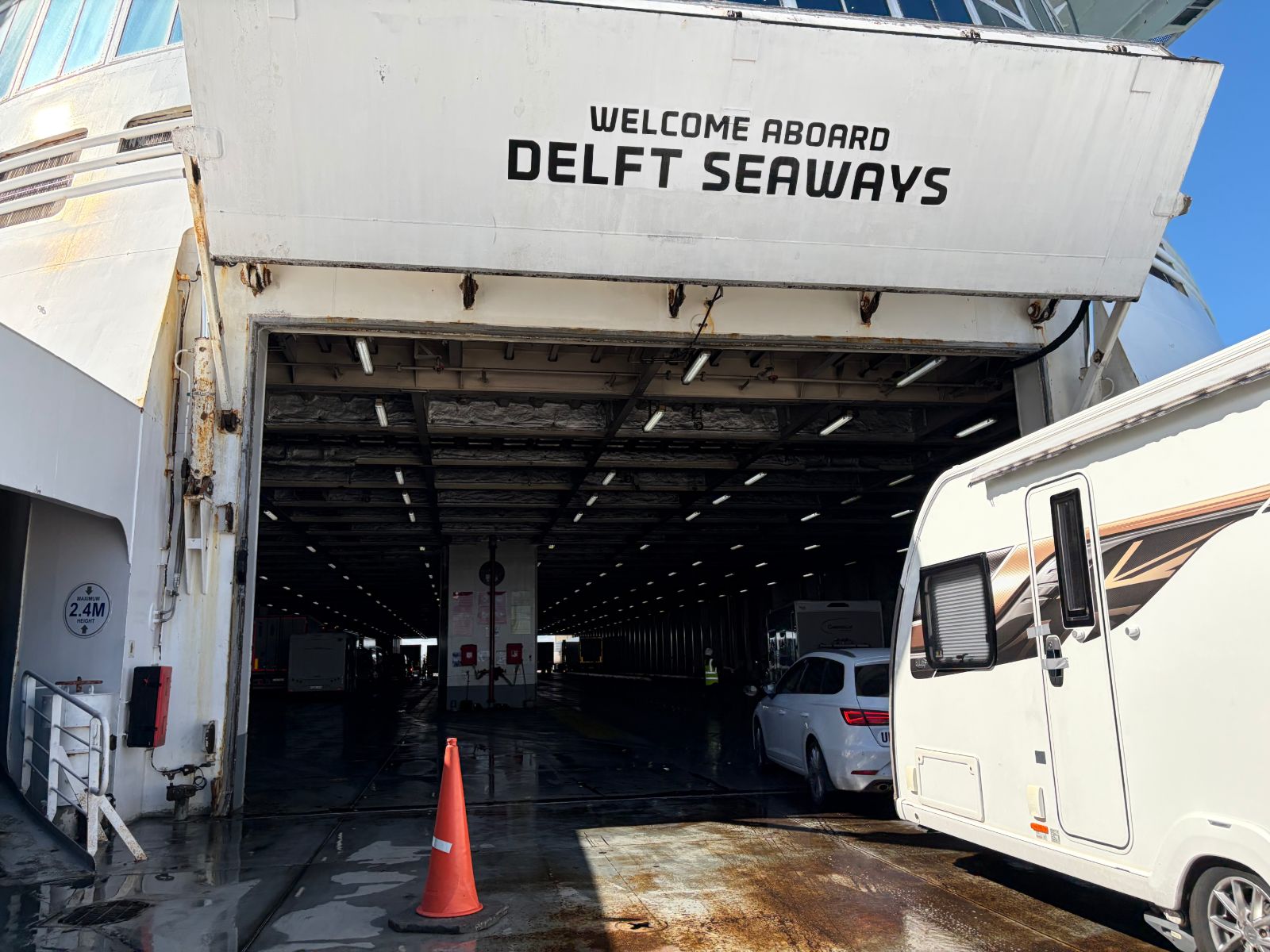 Bow door entrance to the car deck of Delft Seaways with a 'Welcome aboard' sign and a caravan driving on
