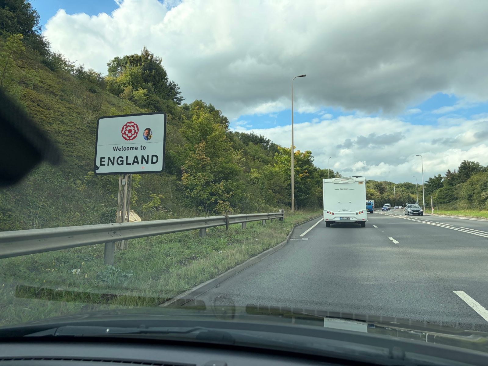 'Welcome to England' road sign beside a dual carriageway in Kent